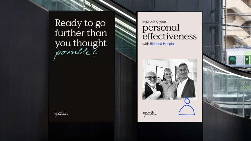 Two vertical posters on a dark wall. The left poster reads, Ready to go further than you thought possible? The right poster promotes Improving your personal effectiveness with Richard Harpin with a black-and-white photo of three smiling people.