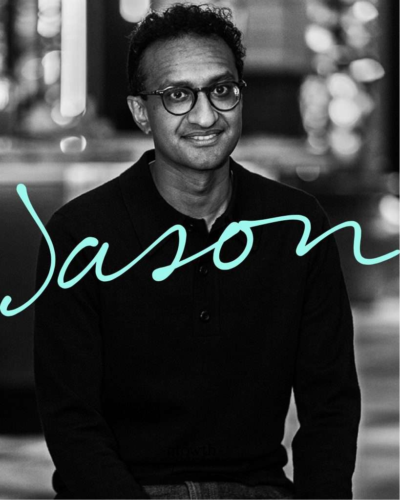 Black and white photo of a man with glasses wearing a dark jumper, seated and smiling at the camera. The word “Jason” is written in large, teal script across the image.
