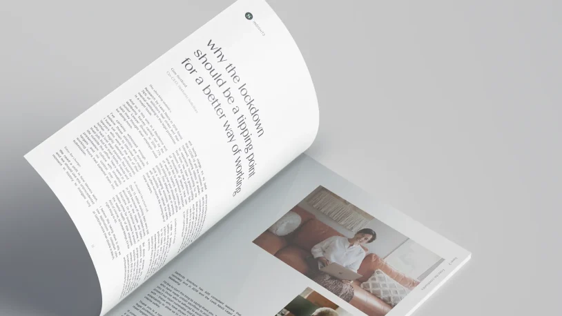 An open magazine on a light surface displays an article titled Why the lockdown should be a turning point for a better way of working and a photo of a person sitting on a sofa with a laptop.