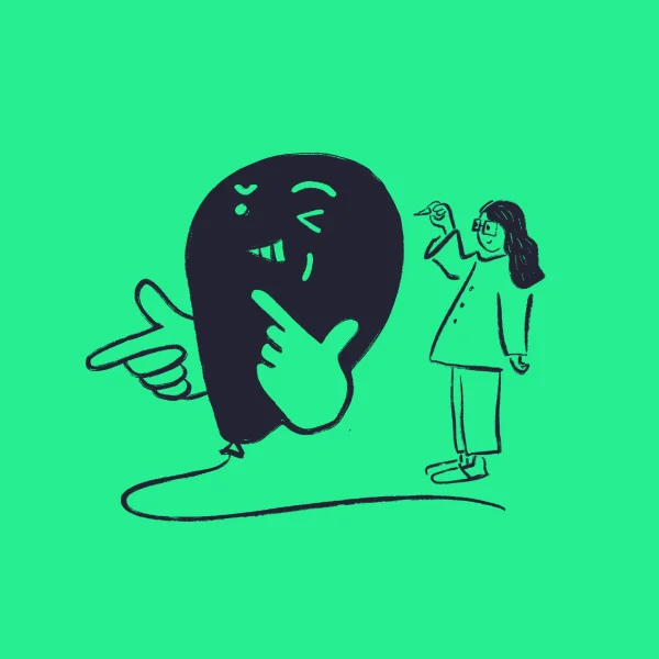 A person with glasses holds a pen and stands near a large, playful balloon character making a wink and finger-gun gesture, both outlined in black on a bright green background.