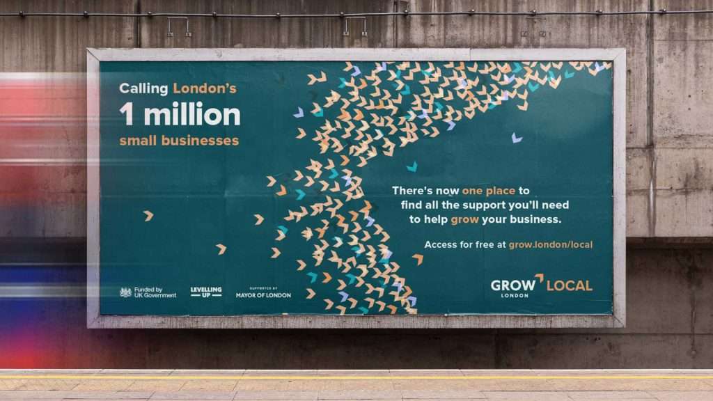 A billboard reads: Calling London’s 1 million small businesses. With a rebrand, there’s now one place to find all the support you’ll need to help grow your business. Orange birds fly right on a blue background.